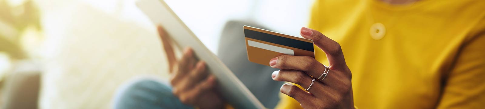 a woman using her debit/credit card for an online purchase